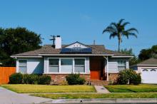 Solar panels on roof of blue cottage in Los Angeles, CA