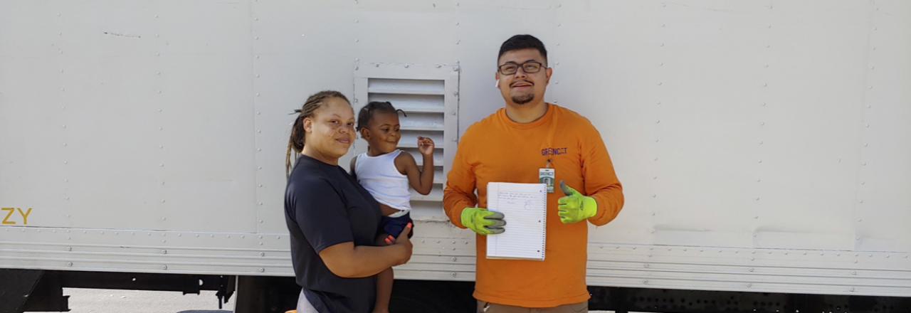 Happy Customer with Small Child and Greencat Employee Happy Customer with Small Child and Greencat Employee