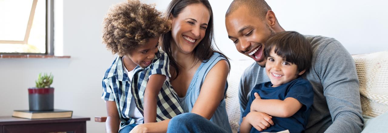 Happy family laughing and playing with each other 