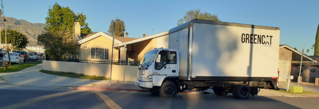 Greencat Truck In Front of House