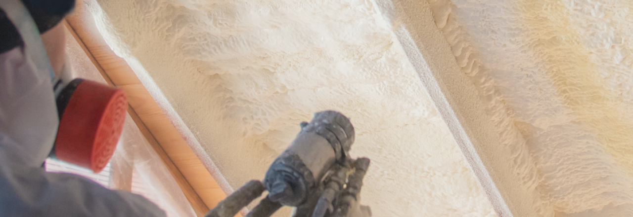 Spray foam insulation being sprayed in attic