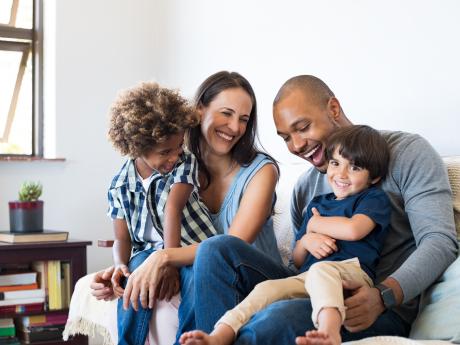 Happy family laughing and playing with each other 