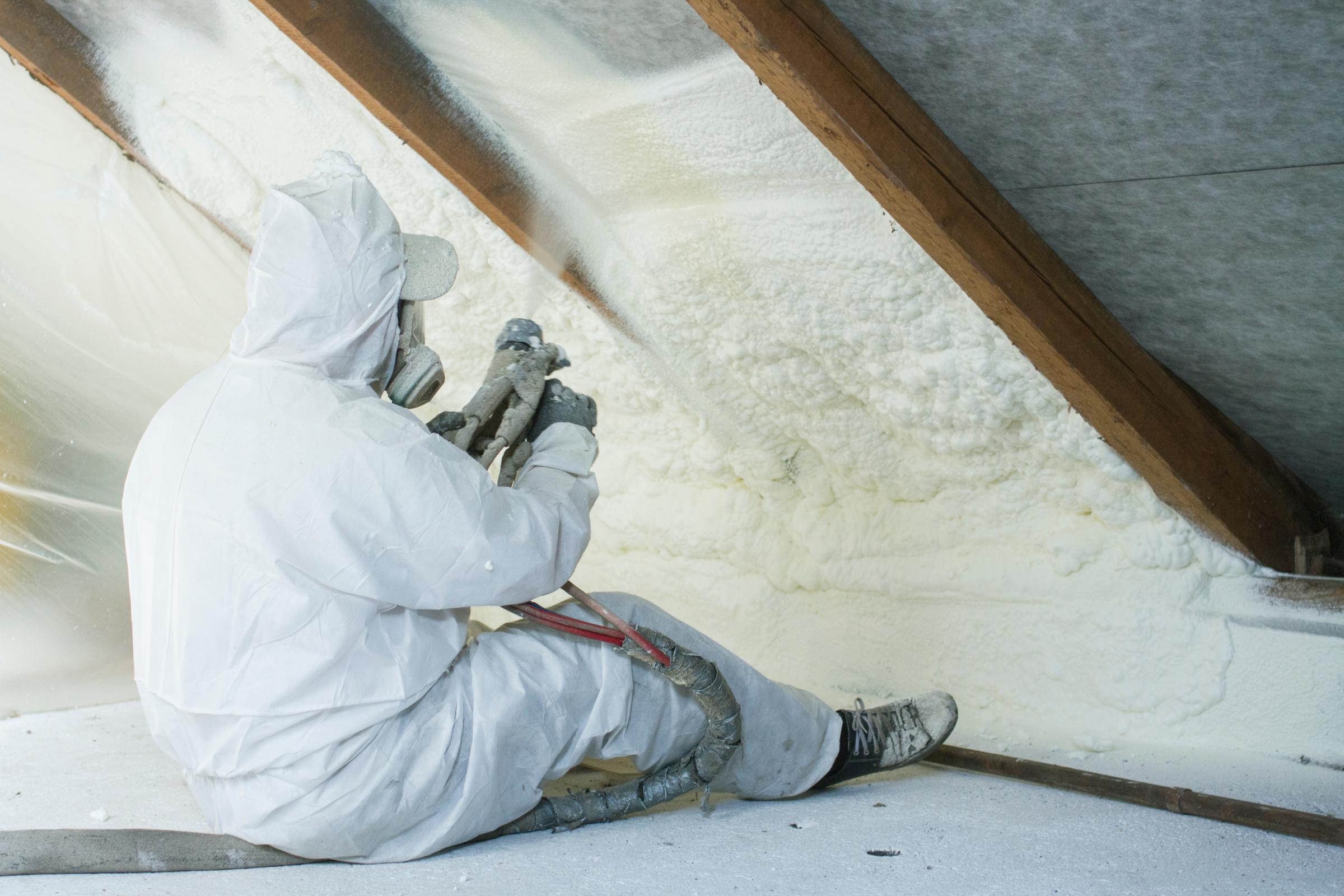 Spray Foam Insulation Being Applied To Attic